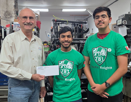 Peter Eberl (left) of Special Electronics and Design in Kincardine, presents a cheque for $1,000 to Kinetic Knights Mohamed Lila and Ibrahim Syed|