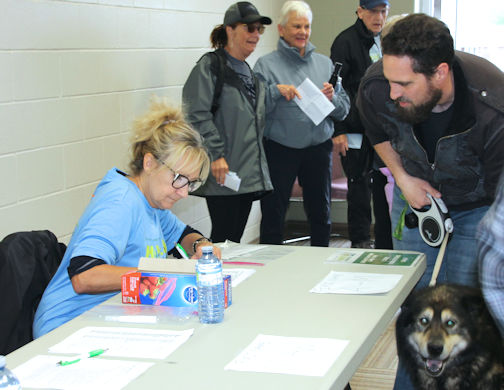 Linda Battler (left) helps register participants in the Hike for Hospice