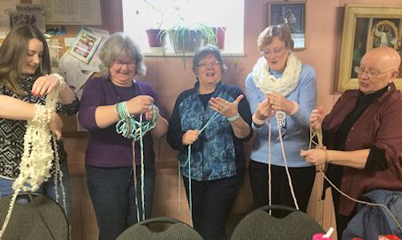 Bervie W.I. ladies learn how to do arm-knitting