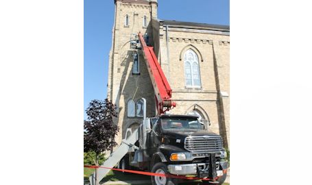 Local masons fix brickwork on tower at Knox Presbyterian Church in Kincardine